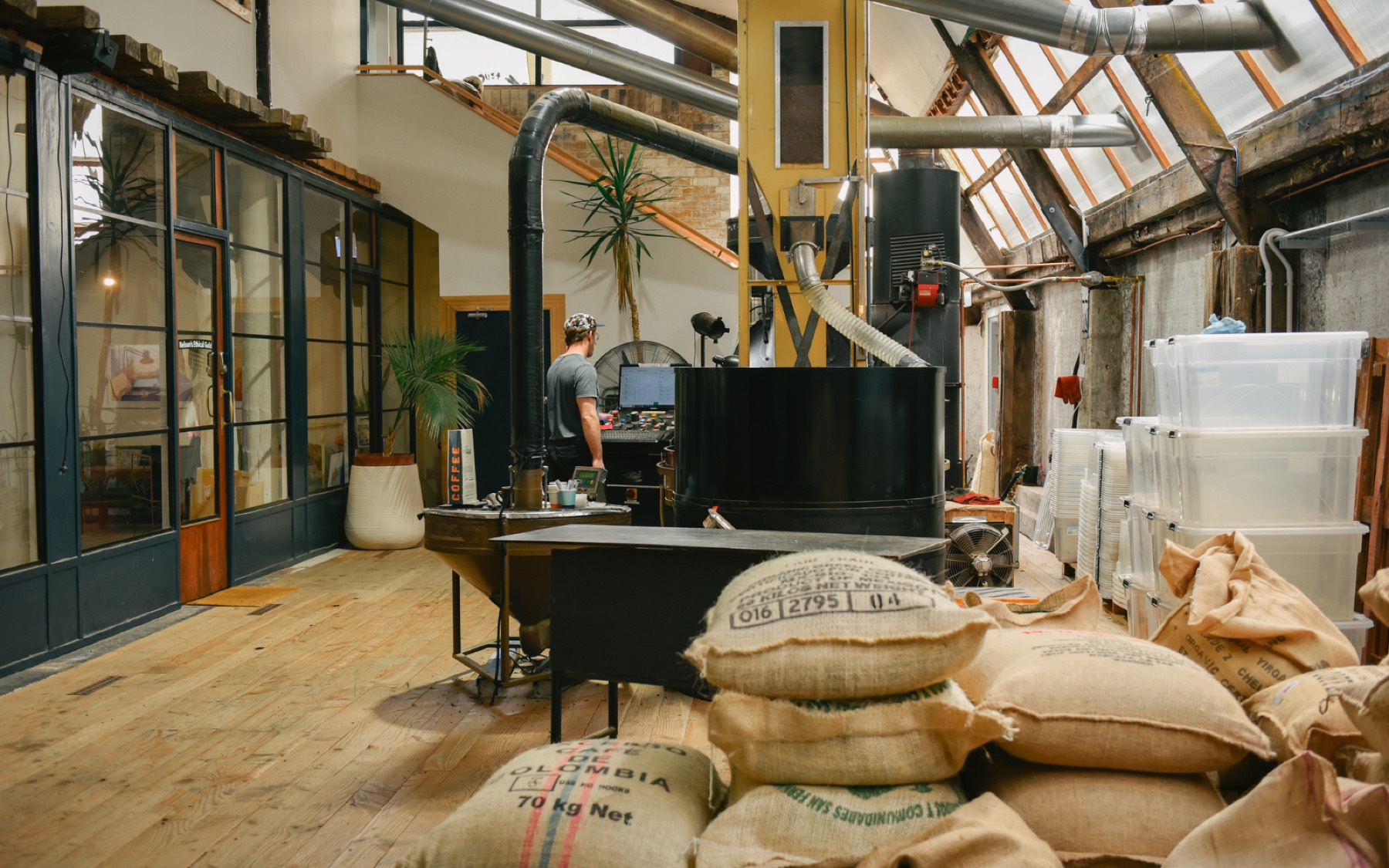The roaster and sacks of green coffee inside the Bridge Street roastery