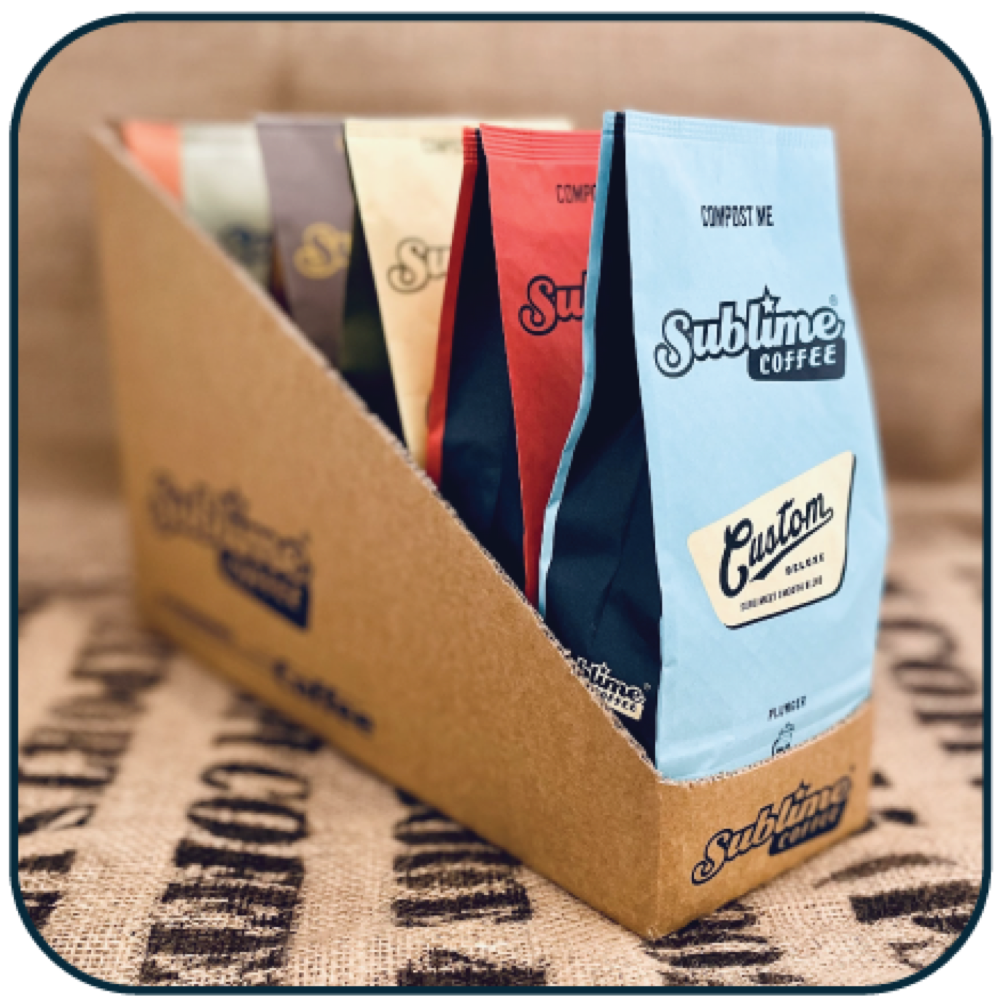 The Sublime sample box with six coffee bags standing in a cardboard tray